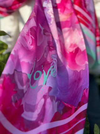 Long Love Peony Silk Scarf in pink and magenta showing the mint green Love inscription