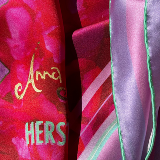 Folded Love Peony Square Scarf detail showing part of the Anna Acciarini Signature and the hand rolled edge in mint green with lilac and pale pink border.