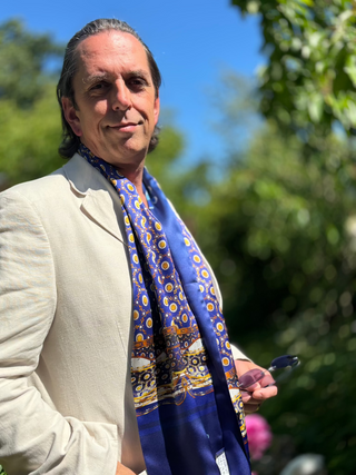 Model wearing the Northumbria long silk scarf draped around neck in summer party evening semi-formal style