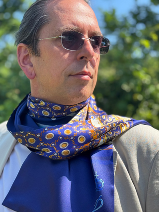 Model shown wearing blue and gold pattern satin scarf for men