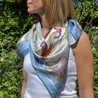 Luxury silk scarf styled in bohemian bandana fashion by model, Chelsea Lovebirds design evoking antique romance and artisanal detail