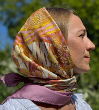 Female model wearing the Derby Pattern 188 scarf as a headscarf under sunlight