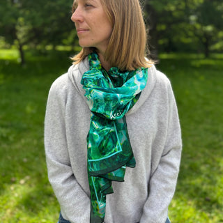 Scarf layered for evening elegance, styled with quiet confidence and fluid silk movement