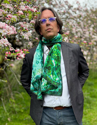 Male model wearing scarf loosely wrapped, styled for stillness and contemporary grace