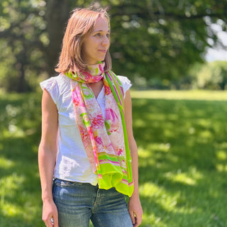 Lime Zest silk scarf styled simply on model in white top and jeans, photographed in dappled sunlight setting