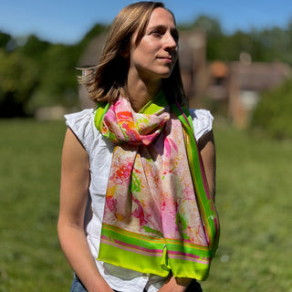 Female model wearing white top and jeans with Lime Zest silk scarf in sunlit garden, wrapped simply around neck