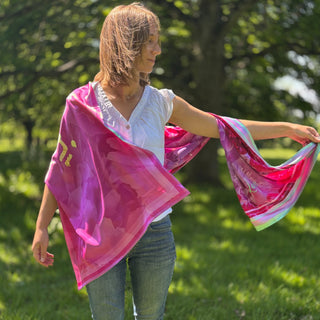 Female model with scarf over shoulder in garden-inspired style, showcasing blush pink and rich fuchsia