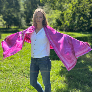 Female model styling Love Peony scarf for spring day, wrapped in blooming peonies and warm tones
