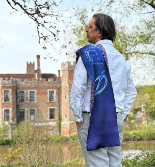Profile view of model wearing Northumbria scarf, styled to express opulent serenity and timeless elegance