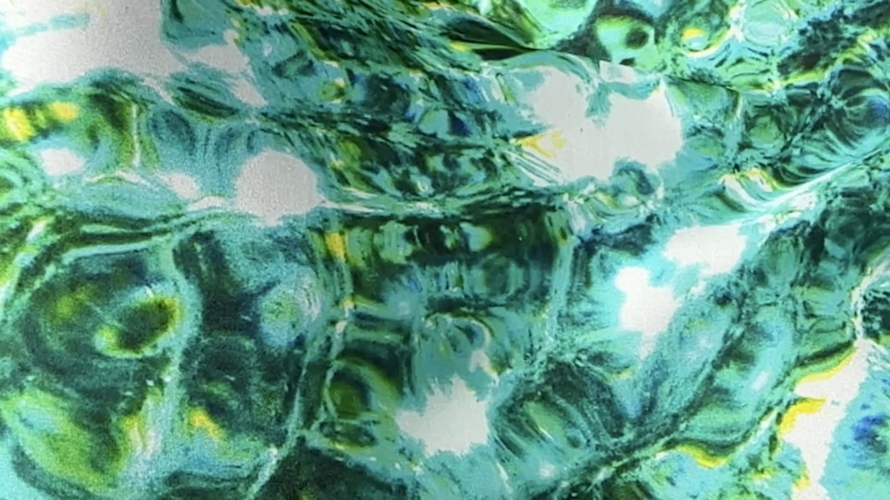A close up slow motion shot of the Green Red Sea Long Silk Scarf billowing in the wind